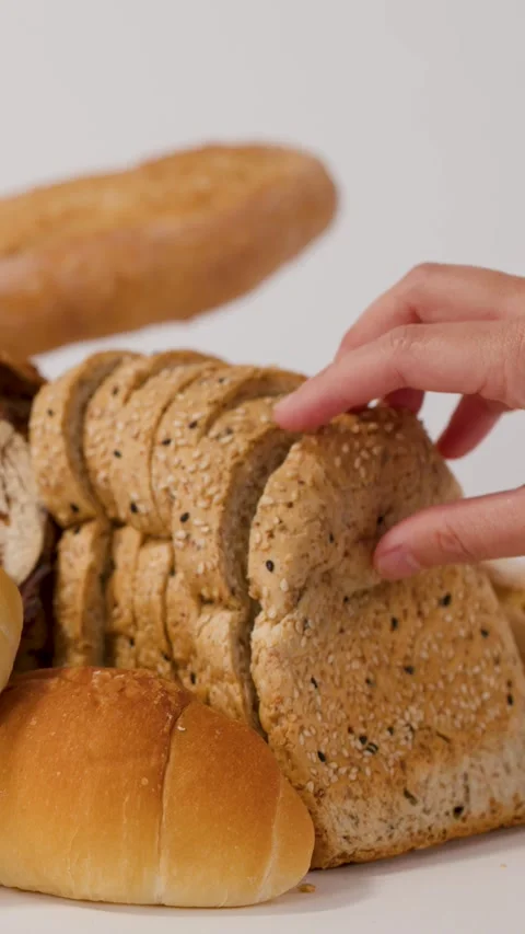 Hand Picking Up Sliced Whole Wheat Bread From Bakery Assortment Stock Footage 337519501