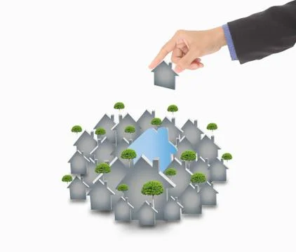 Hand picking up a small house, isolated on a white background Stock Photos