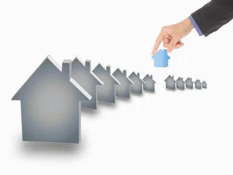 Hand picking up a small house, isolated on a white background Stock Photos