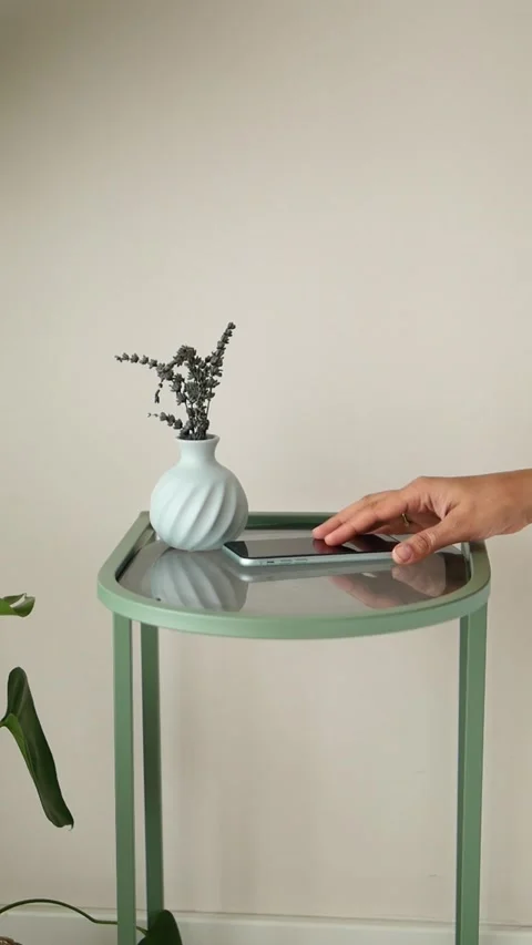 Hand Picking Up Smartphone From Minimalist Side Table Stock Footage 338375879