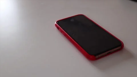 Hand picking up a smartphone from the table. Concept of phone addiction and Stock Footage 304067329