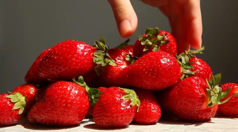 Hand picking up three strawberry with copy space on gray background 動画素材 63230756