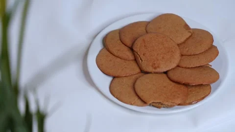 Hand Picking Traditional Date Cookies – Sweet Sticky Pastry on White Background Stock Footage 310769689