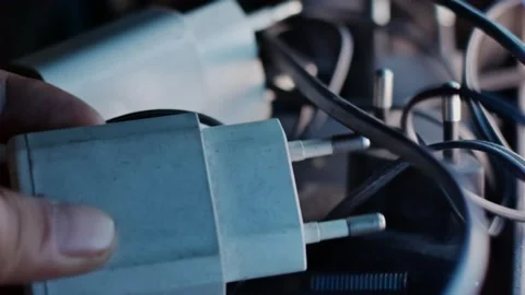 Hand Picking Up White Smartphone Charger From Tangled Cables Electronic Pow.. Vidéo 338224938