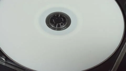 Hand picks up and installs a white CD DVD disc in a plastic box. Stock Footage 137590994