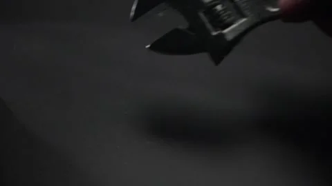 Hand picks up and puts down a adjustable wrench. Stock Footage 278461715