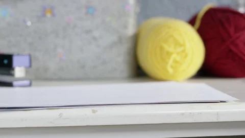 Hand picks up and sets down paper Stock Footage 82809342