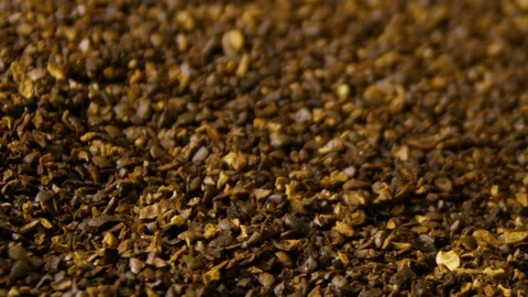 Hand picks up coarsely ground coffee beans in a container. Freshly roasted Stock Footage 114889848