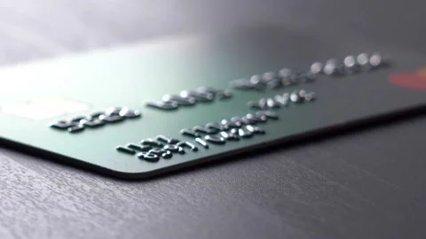 The hand picks up a credit card from the table. 스톡 동영상 152473676