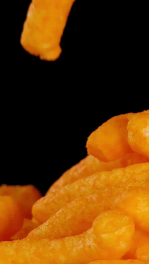 Hand Picks Up Crispy Cheese Puffs Against Black Background Stock Footage 320163669