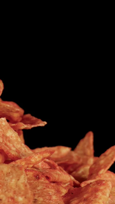 Hand Picks Up Crispy Nacho Tortilla Chip Against Black Background Stock Footage 320163174