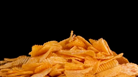 Hand Picks Crispy Potato Chip From Pile on Black Background Stock Footage 321669885