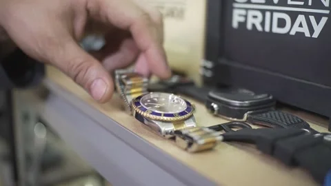 Hand picks up expensive Rolex watch close up Stock Footage 140161253