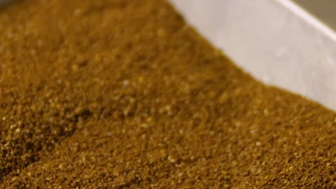 Hand picks up finely ground coffee beans in a container. Freshly roasted Stock Footage 114889836