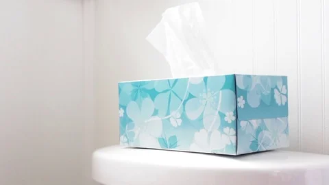 Hand picks out multiple tissues from tissue box in modern bathroom Stock Footage 71252489