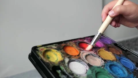 Hand picks up paint with a brush Stock Footage 156675728