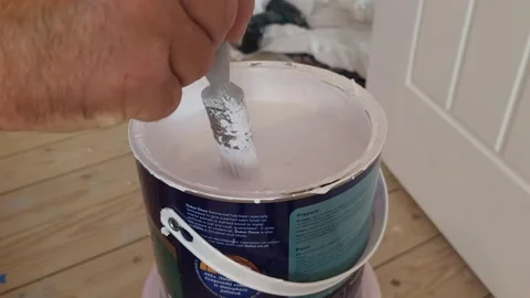 Hand picks up paintbrush, dips it into paint pot Stock Footage 244925798