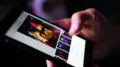 Hand picks photo with Pair on touch phone in night club. Stock Footage 63027079