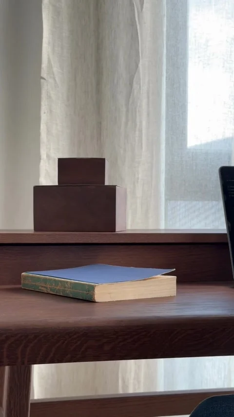 Hand picks up red notebook from a wooden desk Stock Footage 331769922