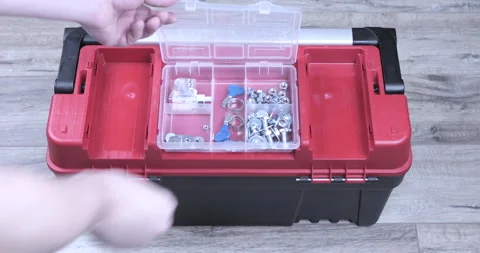 A hand picks up a toolbox Stock Footage 125975249