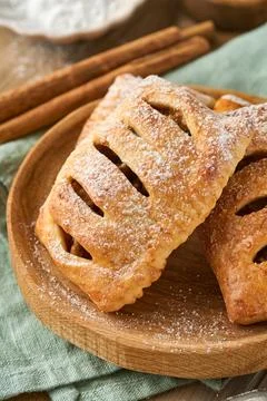 Hand pies. Mini puff pastry or hand pies stuffed with apple and sprinkle suga Stock Photos