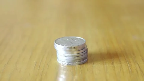 Hand piling and counting silver coin money Stock Footage 322144547