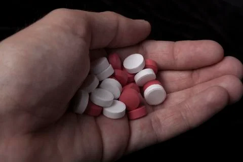 Hand with pills Stock Photos