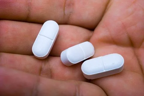 Hand with pills Stock Photos