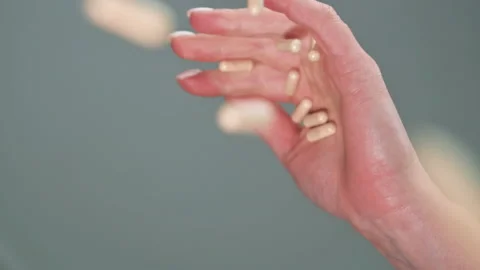 Hand in a pills they fall in slow motion. Theme of dependence on pharmaceutical Stock-Footage 153021265