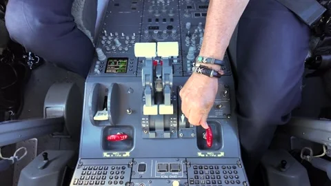 Hand of a Pilot Adjusting the Thrust and Speed Brakes Inside a Modern Jet Stock Footage 338186817