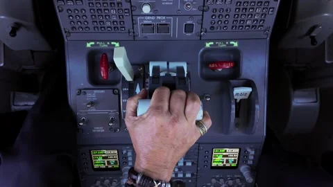 Hand of a Pilot Adjusting the Thrust Levers of a Modern Jet Airplane. Overhead Stock Footage 338186794