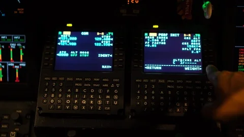 A hand of a pilot pressing button of flight management computer at night time. Stock Footage 109187177