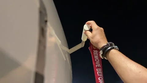 Hand of a Pilot Removing the Remove Before Flight Red Tag Before the First Stock Footage 318455678
