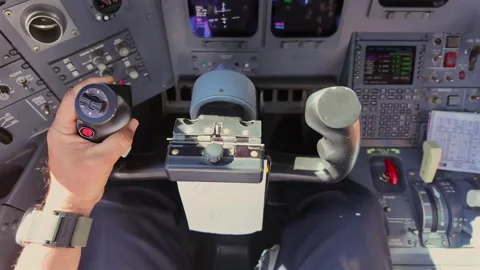 Hand of a Pilot Taking Manual Control of a Jet Airplane Disconnecting the Stock Footage 338186754