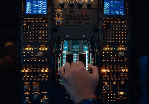 Hand of a pilot at the thrust levers of a jet Stock Photos