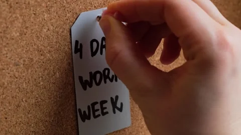 Hand pin note 4 day work week text on paper note pinned to desk four day working Stock Footage 241467841
