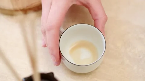 Hand Placed an Empty Cup On The Table After Drinking. - closeup shot Stock Footage 298175992