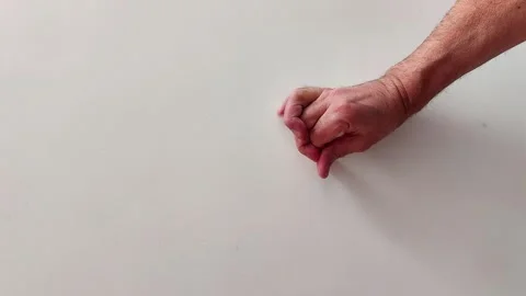 Hand Placed Flat with Fingers Spread on Light Background Surface Video stock 329213470