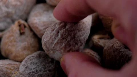 Hand places dried fig covered in powdered sugar. Stock Footage 326452797