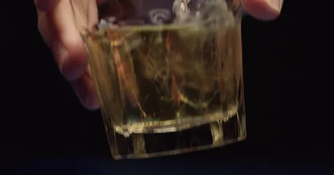 A hand places a drink down in slow motion on an unseen bar isolated Stock Footage 71780026