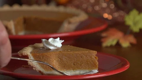 Hand places fork by pie slice topped with cream Stock Footage 96553239