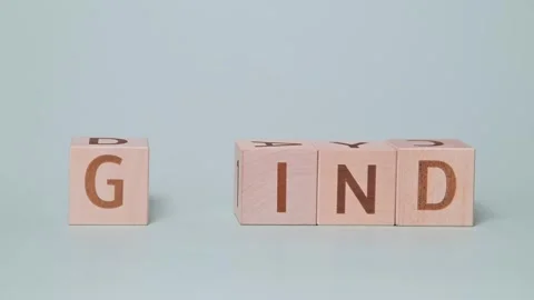 A hand places letter blocks on a flat surface to create different combinations Stock Footage 338187639