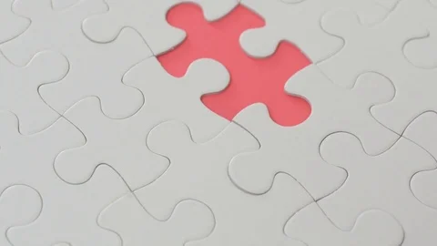 Hand places puzzle on the missing part of the Jigsaw puzzle Stock Footage 74751294