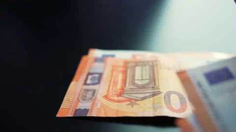 Hand places a stack of 50 euro notes on a dark table with copy space Vidéo 331108929