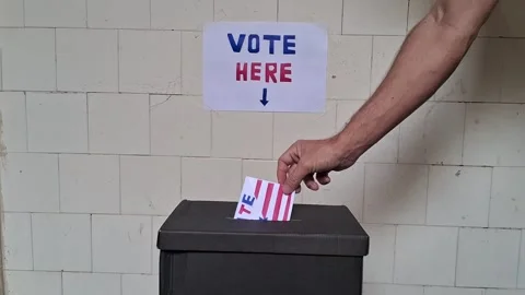 Hand placing ballot inside black voting box for election video footage Stock Footage 341700612