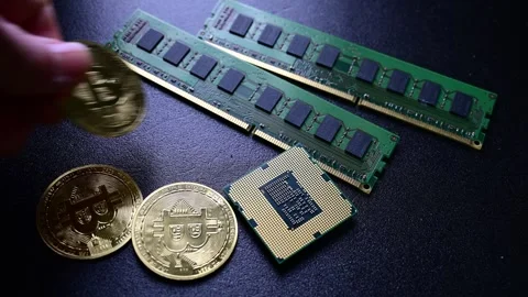 Hand placing bitcoin coin onto computer components representing digital Stock Footage 331121774