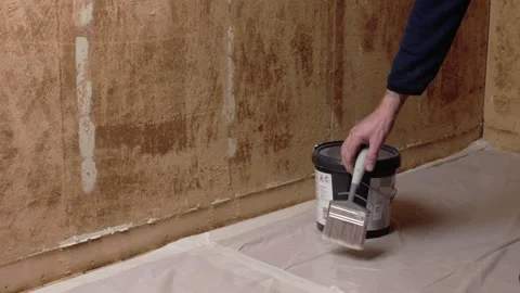 Hand placing brush by paint bucket Stock Footage 327143682
