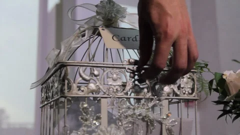 Hand Placing card in wedding cage Stock Footage 92000230