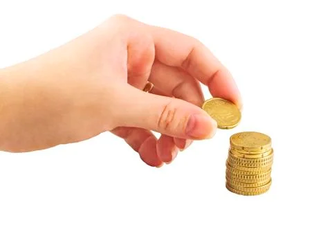 Hand placing coin in the money stack Foto stock