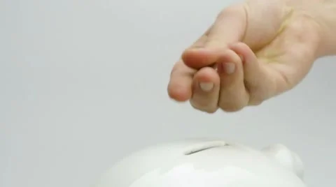 Hand placing coins Stock Footage 7138081